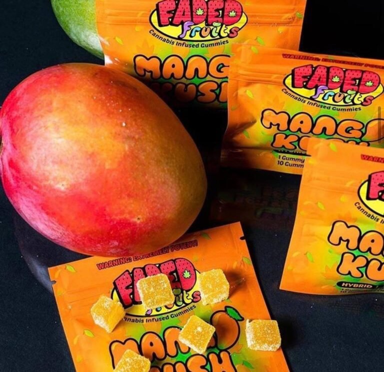 Faded Fruits mango flavored gummy packs beside a fresh mango