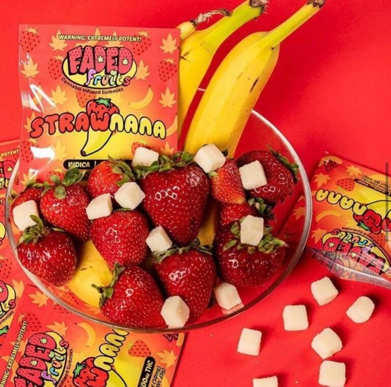 Faded Fruits gummies in a bowl with fresh strawberries