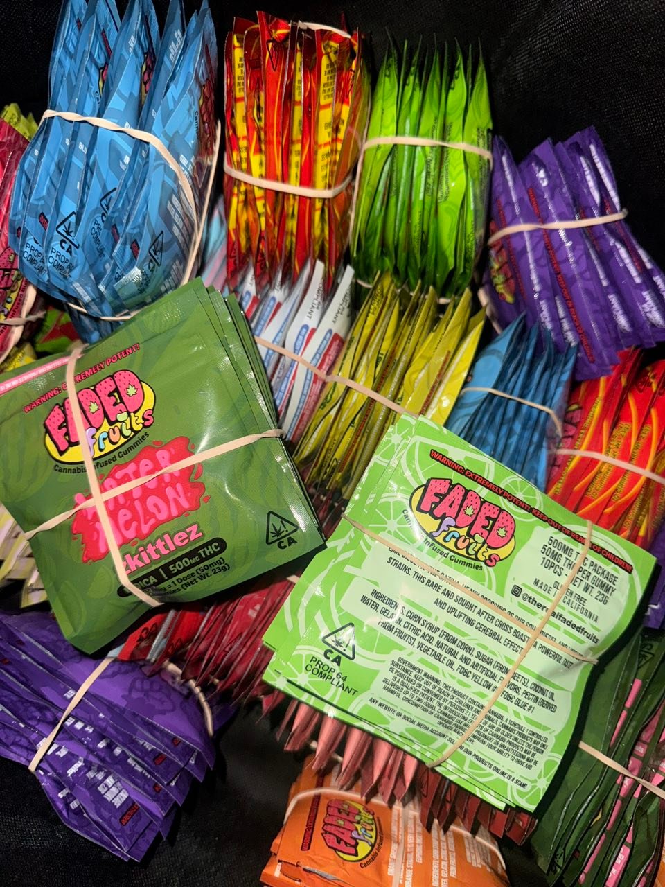Assorted Faded Fruits gummy packs lined up in a range of flavors